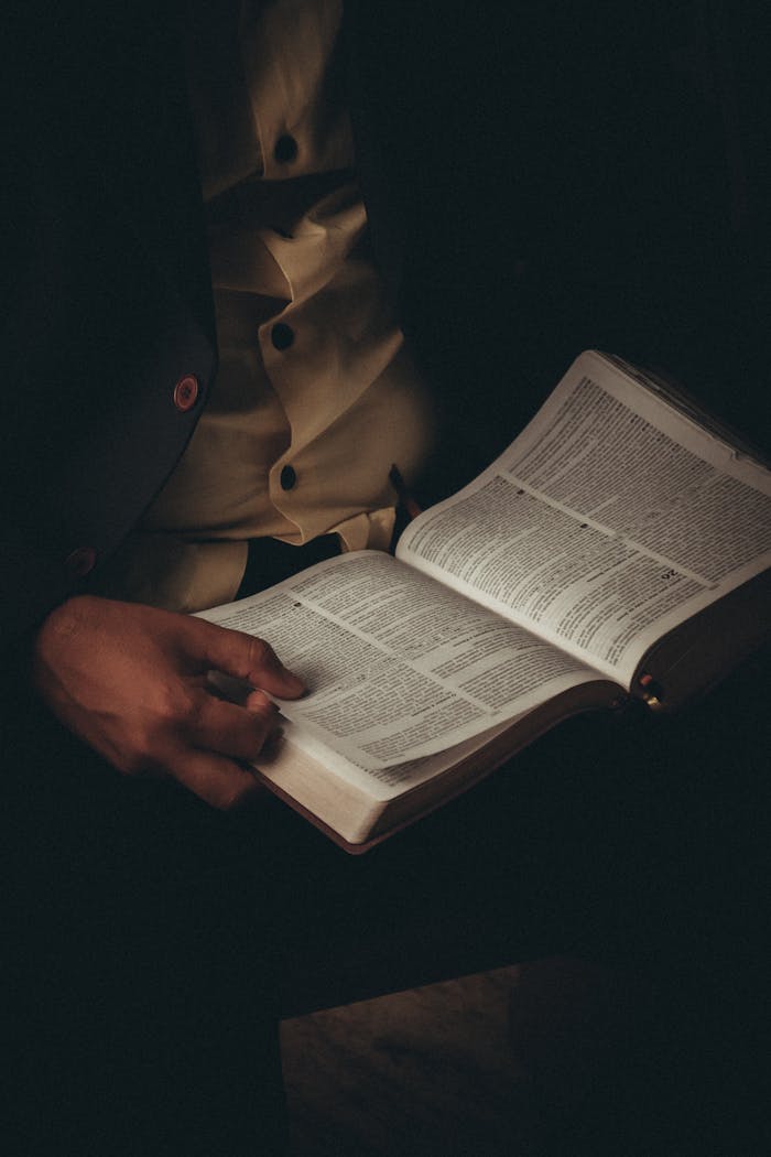 A person engaging in thoughtful Bible study, highlighting the intimate exploration of faith and scripture.